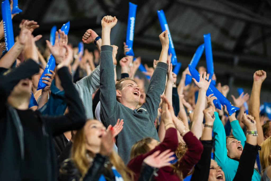 A man cheers on his team from a seat he bought from a ticketing resale site, one of the best places to sell season tickets.