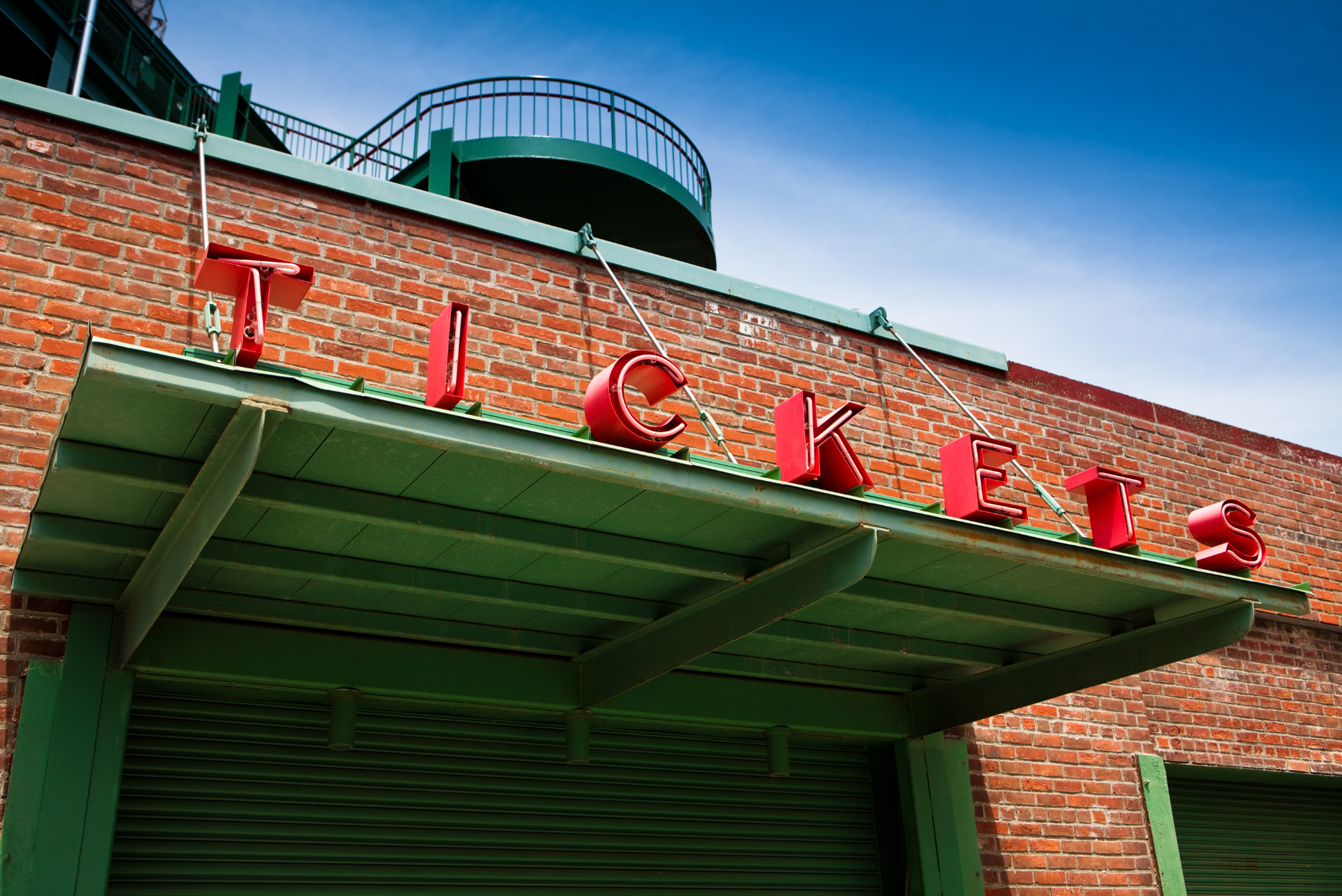 A green ballpark awning reading “Tickets” in red represents an article on the best event ticketing platforms.