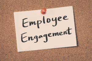 A small note that says “Employee Engagement” is tacked to a corkboard, representing employee engagement and retention.