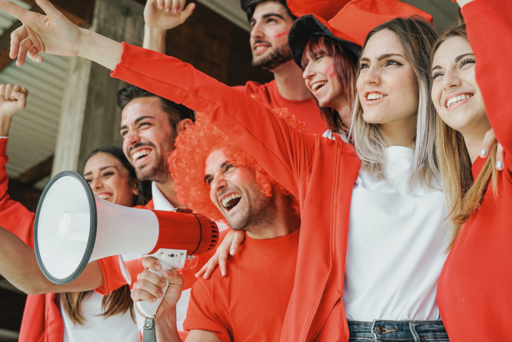 A group of professionals strengthen their business-client relationship by enjoying a local football team’s games together.